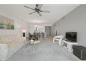 Open living room with a ceiling fan, TV, furniture, and a view to other living spaces at 7910 Sun Island S Dr # 302, South Pasadena, FL 33707