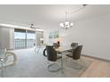 Living room with balcony access and water view adjoins the dining area with seating for four at 7910 Sun Island S Dr # 302, South Pasadena, FL 33707