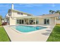 Backyard pool with patio, ceiling fans, and ample space for relaxing and entertaining at 995 Eden Isle Ne Dr, St Petersburg, FL 33704