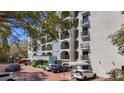 View of a building exterior with covered parking spots and balconies with dark railings at 105 4Th Ne Ave # 501, St Petersburg, FL 33701