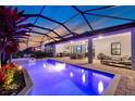 Gorgeous screened pool and spa with outdoor kitchen and patio furniture for outdoor living at 14522 Woodland Spur Dr, Lithia, FL 33547