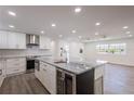 Bright, updated kitchen with white cabinets, stainless appliances, and a large center island at 163 Dolphin E Dr, Oldsmar, FL 34677