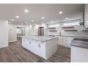 Spacious kitchen featuring white cabinets, stainless steel appliances, and stylish gray countertops at 163 Dolphin E Dr, Oldsmar, FL 34677