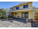 Exterior of a home featuring a cozy backyard patio area with a fire pit at 2073 Madrid N Ct, Clearwater, FL 33763