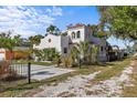 Beautiful two-story home featuring a red tile roof, white stucco exterior, and mature landscaping at 2227 29Th S St, St Petersburg, FL 33712