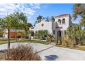 Charming two-story home featuring a red tile roof, white stucco exterior, and beautiful landscaping at 2227 29Th S St, St Petersburg, FL 33712