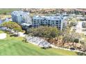 Beautiful condo complex featuring lush green lawns, a serene lake, and a golf course at 2333 Feather Sound Dr # A308, Clearwater, FL 33762