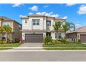 Beautiful two-story home with manicured lawn, landscaped garden, and a paved driveway leading to a two-car garage at 3107 Mountain Spruce Ter, Wesley Chapel, FL 33543