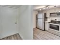 Modern kitchen featuring stainless steel appliances, light grey cabinets, and wood-look flooring at 313 Martha Ln # 4, Oldsmar, FL 34677
