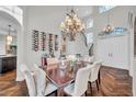 Sophisticated dining room features hardwood floors, chandelier, wine storage, and staircase leading to the upper level at 3598 10Th Ne St, St Petersburg, FL 33704