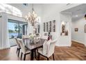 Elegant dining area features wood floors, large windows with water views, chandelier, and wine racks for sophisticated living at 3598 10Th Ne St, St Petersburg, FL 33704