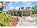 Inviting single-story home featuring a well-kept lawn, charming curb appeal and attached garage at 375 Magnolia Rd, Venice, FL 34293