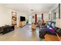 Inviting living room with terrazzo floors, neutral walls, and comfortable seating at 375 Magnolia Rd, Venice, FL 34293