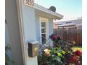 Side exterior view with a mailbox, bird feeder and flower bed at 3850 6Th N Ave, St Petersburg, FL 33713