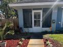 A close view of the house featuring a walkway to a screened porch entry and landscaped front yard at 3850 6Th N Ave, St Petersburg, FL 33713