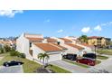Charming townhouses with well-maintained lawns, driveways, and distinctive metal roofs at 4358 Outrigger Ln, Tampa, FL 33615