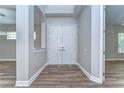 Entryway with white double doors, wood floors, arched entry, and neutral paint at 5224 Fairway One Dr, Valrico, FL 33596