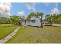 Well-maintained home with gray siding, a stone pathway, and a neatly manicured lawn at 5601 2Nd N Ave, St Petersburg, FL 33710