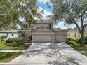 Charming two-story home featuring a spacious driveway and well-manicured landscaping at 6308 Bridgevista Dr, Lithia, FL 33547