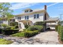 Gorgeous two-story home featuring a well-manicured lawn, charming front entrance, and convenient covered carport at 701 S Edison Ave, Tampa, FL 33606