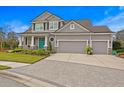 Beautiful two-story house with a three-car garage, well-maintained lawn, and elegant landscaping at 7820 Marsh Pointe Dr, Tampa, FL 33635