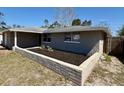 View of home with landscaping, showcasing the stone and cement block front yard at 8708 Robilina Rd, Port Richey, FL 34668