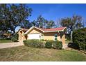 Relaxing side exterior view of home with manicured shrubbery and brick paver driveway at 9805 Hermosillo Dr, New Port Richey, FL 34655