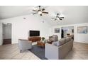 Bright living room featuring tile flooring, ceiling fans, and comfortable seating arrangement at 902 Estelle Ave, Brandon, FL 33511