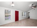 Bright living room features tile floors, a ceiling fan, and natural light from several windows at 902 Estelle Ave, Brandon, FL 33511