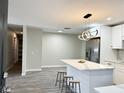 Open kitchen featuring stainless steel appliances, marble countertops, and a convenient breakfast bar at 1039 N Missouri Ave, Clearwater, FL 33755