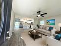 Bright, open-concept living room with modern furnishings and a seamless flow into the kitchen at 1039 N Missouri Ave, Clearwater, FL 33755