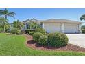 Beautiful single-Gathering home featuring a manicured lawn and a spacious two-car garage at 1145 Boundary Blvd, Rotonda West, FL 33947