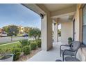 Relaxing front porch with comfortable seating and views of the manicured landscaping and neighborhood at 12857 Satin Lily Dr, Riverview, FL 33579