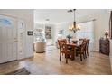 Bright dining room featuring a wood table, a chandelier, and a view into the living area at 13247 Palmilla Cir, Dade City, FL 33525