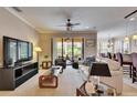 Comfortable living room with a ceiling fan, sliding glass doors to the lanai, and neutral decor at 144 Silver Falls, Apollo Beach, FL 33572