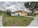Single-story home with attached garage, white fence, and spacious front yard, perfect for outdoor activities at 1610 Bondurant Way, Brandon, FL 33511