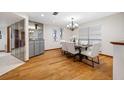 Well-lit dining room with modern chandelier, and a large window next to view of mirrored wall at 1906 Del Oro Ct, Dunedin, FL 34698