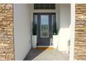 Inviting entryway featuring a decorative glass door, neutral finishes, and space for plants at 19730 Preservation Woods Dr, Lutz, FL 33558