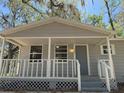 Inviting front porch with white railing and stairs, perfect for relaxing outdoors at 203 D Street, Brooksville, FL 34601