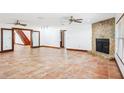 Spacious living room featuring a stone fireplace, large tile flooring and lots of natural light at 2213 Spanish Vistas Dr, Dunedin, FL 34698