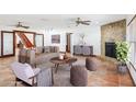 Staged living room with a stone fireplace, neutral sofa, and tile flooring at 2213 Spanish Vistas Dr, Dunedin, FL 34698