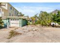 View of the front yard of a home with an attached garage and mature trees at 300 16Th Ave, Indian Rocks Beach, FL 33785