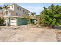 Exterior view of a two-story home with a garage and ample front yard space at 300 16Th Ave, Indian Rocks Beach, FL 33785