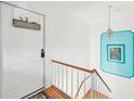 Bright hallway with white door and a picture with a turquoise border on the wall at 4158 Tamiami Trl # R3, Port Charlotte, FL 33952