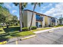 Inviting two-story condo with a private balcony and lush landscaping at 4215 E Bay Dr # 1701C, Clearwater, FL 33764