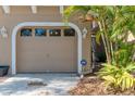 Garage and driveway with beautiful tropical foliage at 4266 Preserve Pl # 4266, Palm Harbor, FL 34685