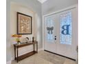 Inviting foyer featuring elegant double doors, decorative accents, and tile flooring at 4411 Culbreath Rd, Valrico, FL 33596