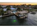 Beautiful aerial view of a waterfront property featuring a boat lift, dock, and in-ground swimming pool at 5105 W Longfellow Ave, Tampa, FL 33629