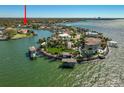 Stunning aerial view of waterfront properties, showcasing lush landscaping, private docks, and serene water views at 5105 W Longfellow Ave, Tampa, FL 33629