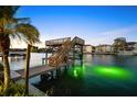 Picturesque waterfront dock with a boat lift and a cozy upper deck for enjoying scenic views at 5105 W Longfellow Ave, Tampa, FL 33629